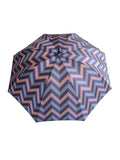 Luxury slim umbrella with jewel chevron canopy design, elegant black frame and striking gold handle by David David, a fashion accessories brand and print studio based in London England, specialising in bold geometric print