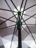 Luxury slim umbrella with stunning monochrome canopy design, elegant black frame and striking gold handle by David David, a fashion accessories brand and print studio based in London England, specialising in bold geometric print