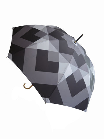Luxury slim umbrella with stunning monochrome canopy design, elegant black frame and striking gold handle by David David, a fashion accessories brand and print studio based in London England, specialising in bold geometric print