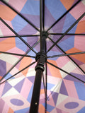 Luxury slim umbrella with stunning monochrome canopy design, elegant black frame and striking gold handle by David David, a fashion accessories brand and print studio based in London England, specialising in bold geometric print