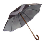 Luxury slim umbrella with stunning monochrome canopy design, elegant black frame and striking gold handle by David David, a fashion accessories brand and print studio based in London England, specialising in bold geometric print