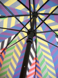 Luxury slim umbrella with bright chevron print, elegant black frame and striking gold handle by David David, a fashion accessories brand and print studio based in London England, specialising in bold geometric print