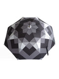Luxury slim umbrella with stunning monochrome canopy design, elegant black frame and striking gold handle by David David, a fashion accessories brand and print studio based in London England, specialising in bold geometric print